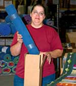 employee packing a shipping tube
